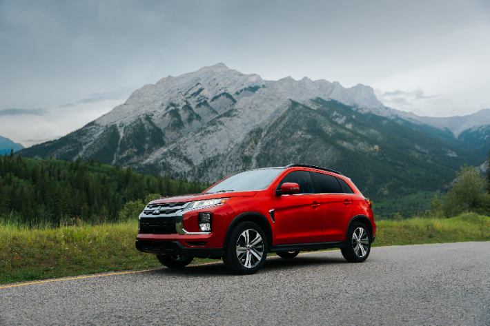 A red RVR parked in front of a mountain