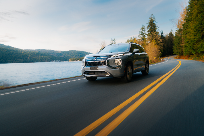 The Outlander cornering in a lane on a coastal road