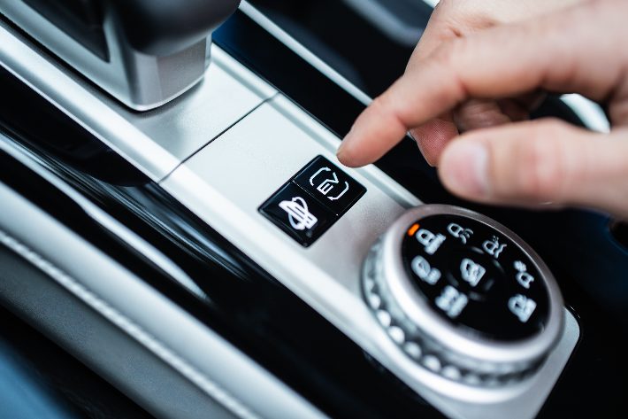 A driver toggling EV modes in the Outlander PHEV