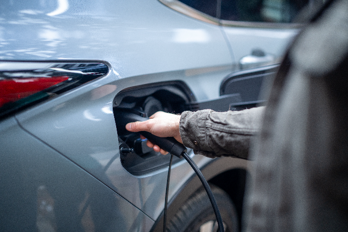 A man plugging in the Outlander PHEV