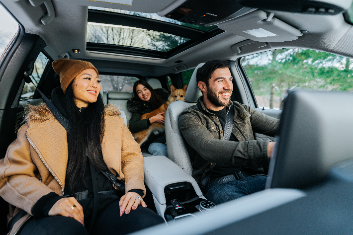 A family smiling in the Outlander PHEV
