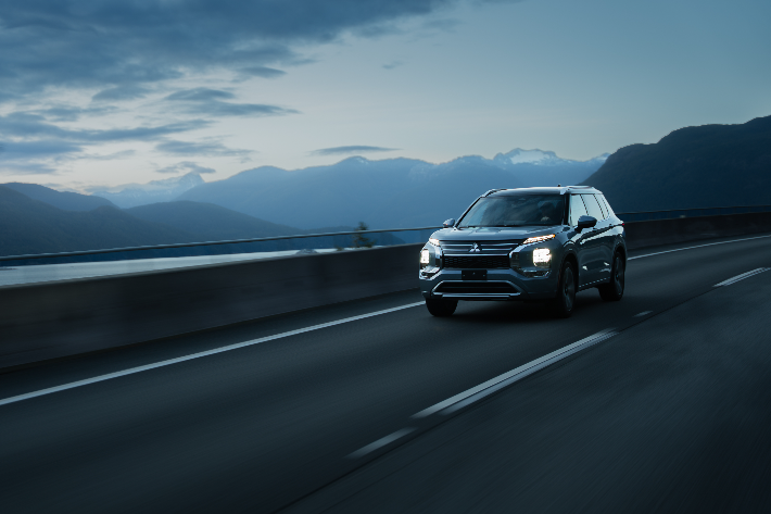 The Outlander PHEV driving on a two-lane highway