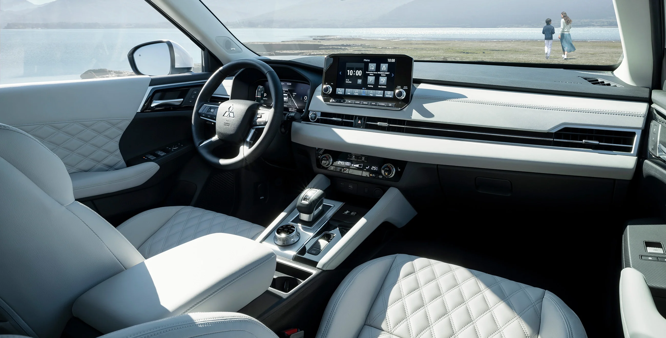 White leather interior of the 2025 Mitsubishi Outlander PHEV with diamond stitching detail and accents.